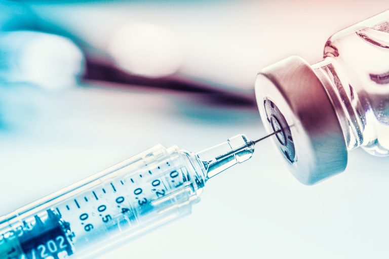 Close-up medical syringe with a vaccine.